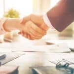 Handshake between landlord and tenant for rental agreement.