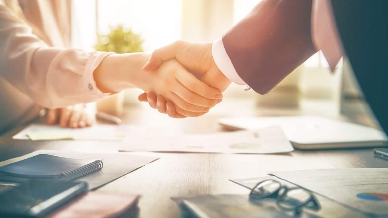 Handshake between landlord and tenant for rental agreement.