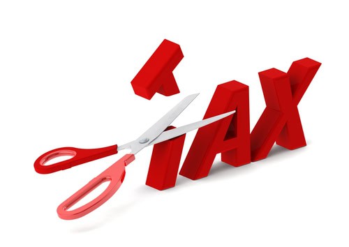 Scissors cutting through the word 'TAX' symbolising tax reduction.