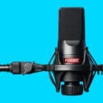 Professional podcast microphone on blue background for Landlord Today.