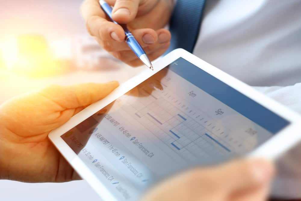 Person analyzing property data on a tablet for landlord insights.