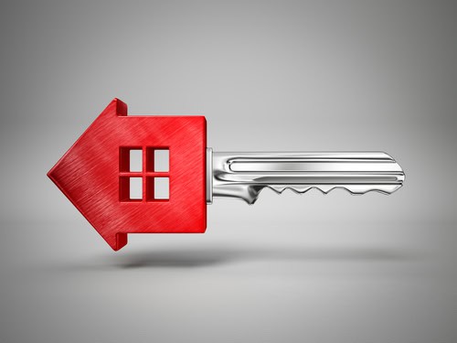 Key with house-shaped head representing property rental or ownership.