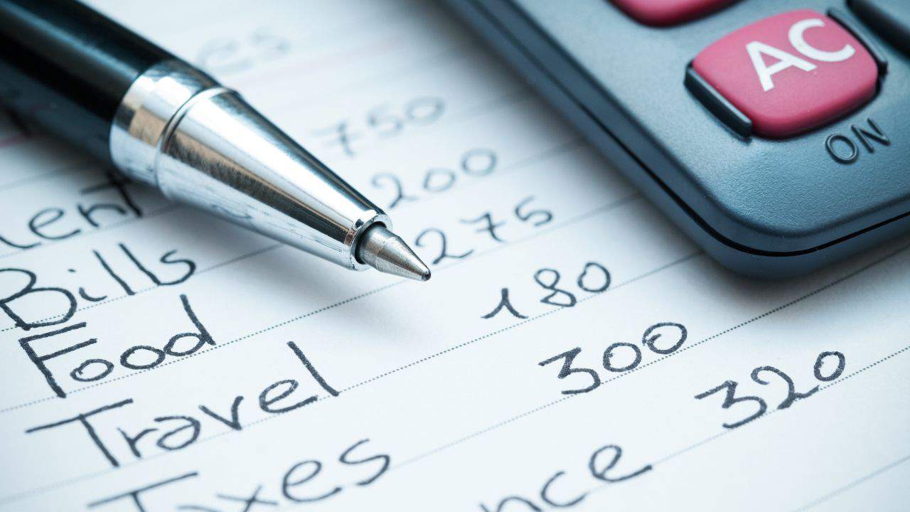 Close-up of a pen, calculator, and financial notes for landlords.